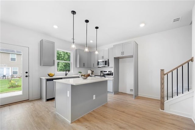 150 Chandler Trce, Covington, GA 30016 - kitchen featuring gray cabinets, appliances with stainless steel finishes, light wood-type flooring, light countertops, and recessed lighting