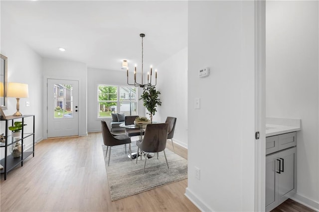150 Chandler Trce, Covington, GA 30016 - dining space featuring a chandelier, light wood-type flooring, and baseboards