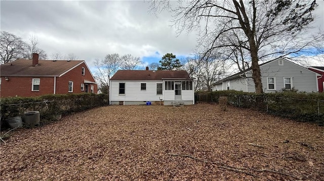 back of property with a fenced backyard