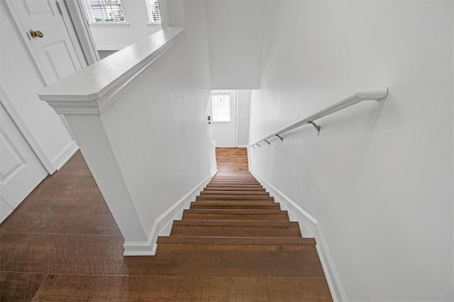 stairs featuring baseboards and wood finished floors