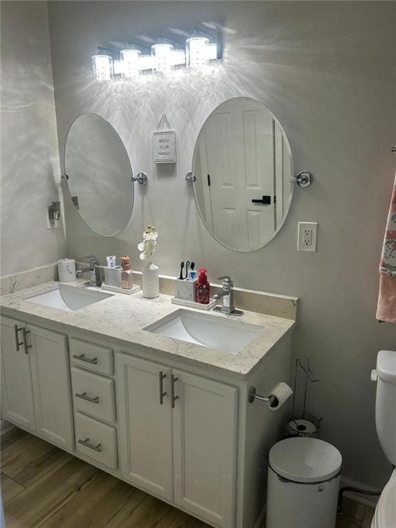 bathroom featuring hardwood / wood-style flooring, vanity, and toilet