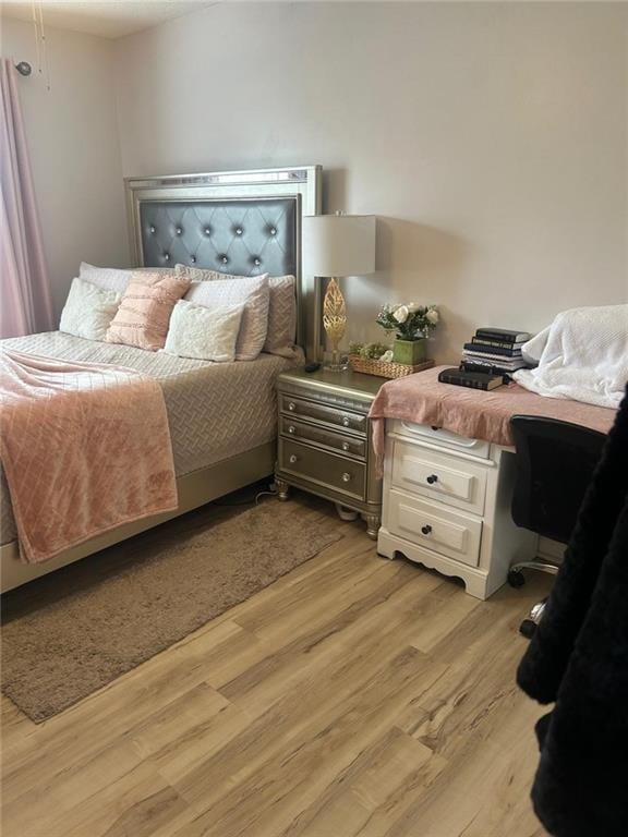 bedroom with light hardwood / wood-style flooring