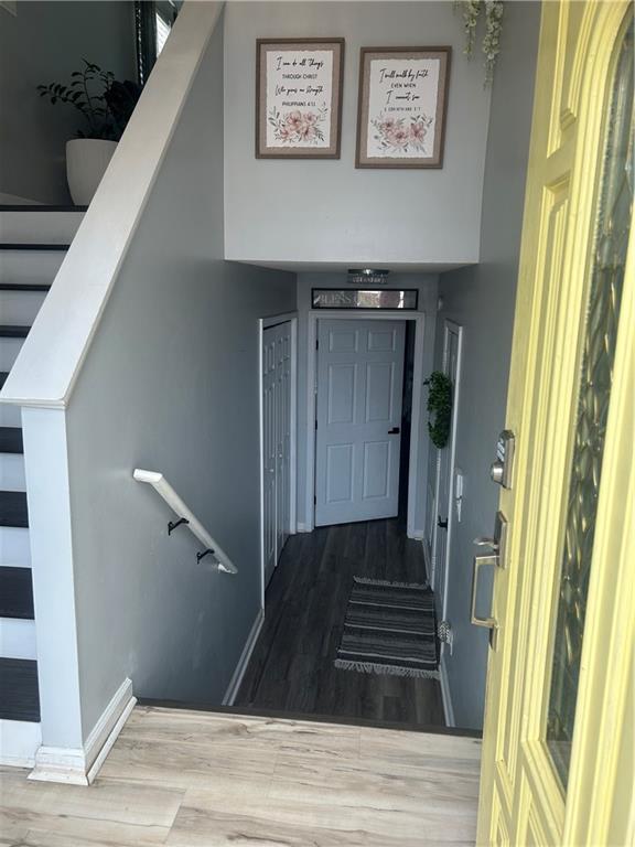 stairs with hardwood / wood-style flooring