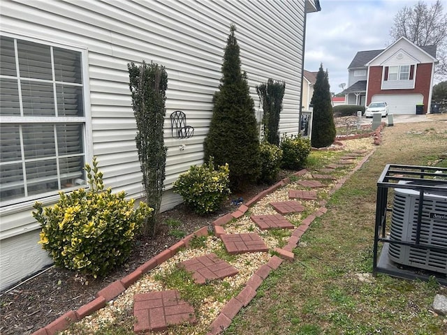 view of side of home with central AC unit