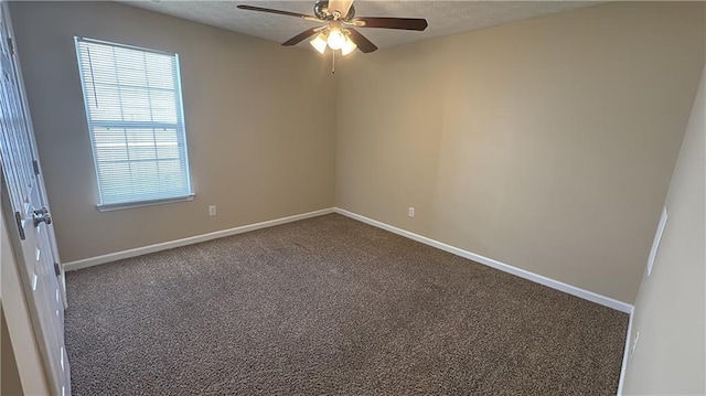 carpeted spare room featuring ceiling fan