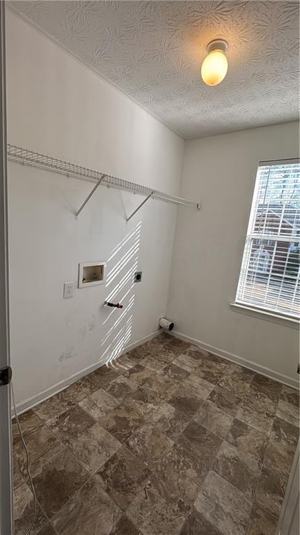 laundry area with washer hookup and a textured ceiling