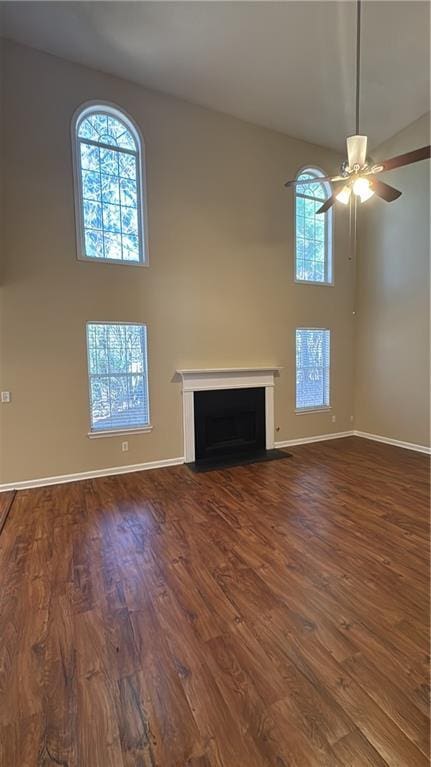 unfurnished living room with ceiling fan and dark hardwood / wood-style floors