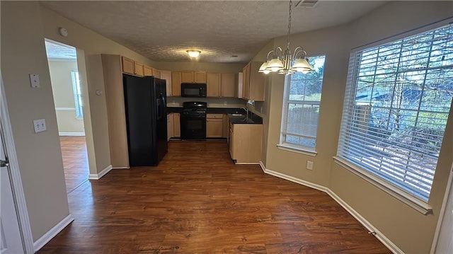 kitchen with an inviting chandelier, decorative light fixtures, dark hardwood / wood-style flooring, and black appliances