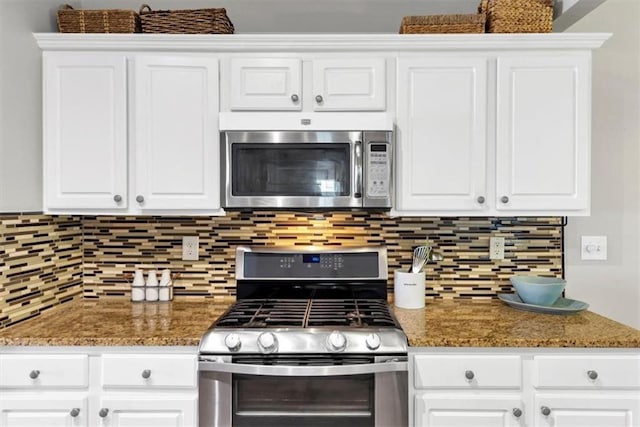 kitchen featuring white cabinets, appliances with stainless steel finishes, and decorative backsplash