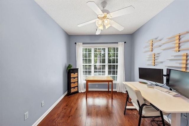 office featuring baseboards, a ceiling fan, dark wood finished floors, and a textured ceiling