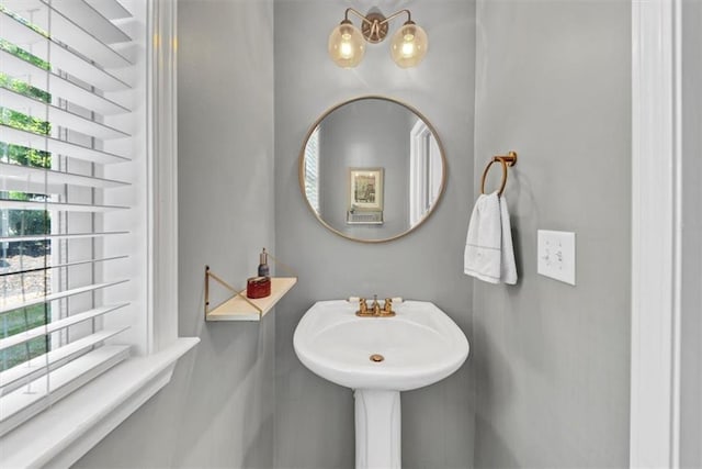 bathroom with plenty of natural light and a notable chandelier
