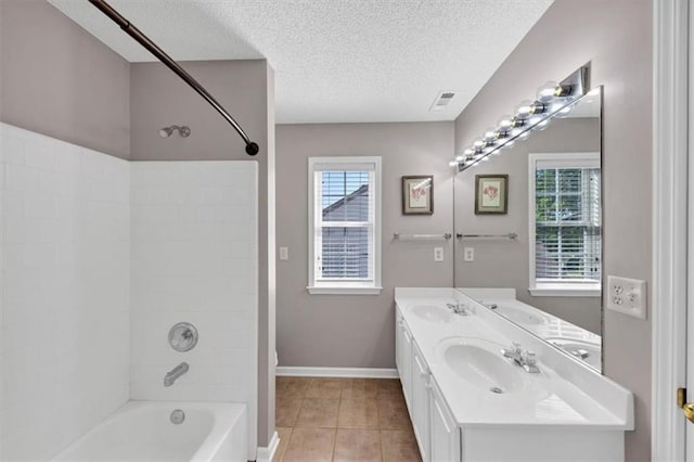 full bathroom featuring baseboards, a sink, a textured ceiling, and  shower combination