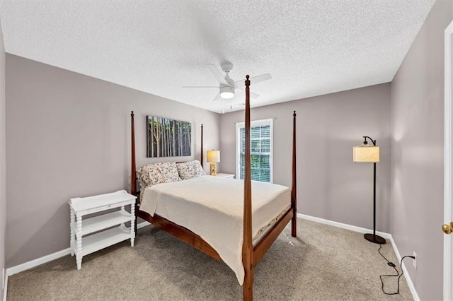 bedroom with a ceiling fan, baseboards, light colored carpet, and a textured ceiling