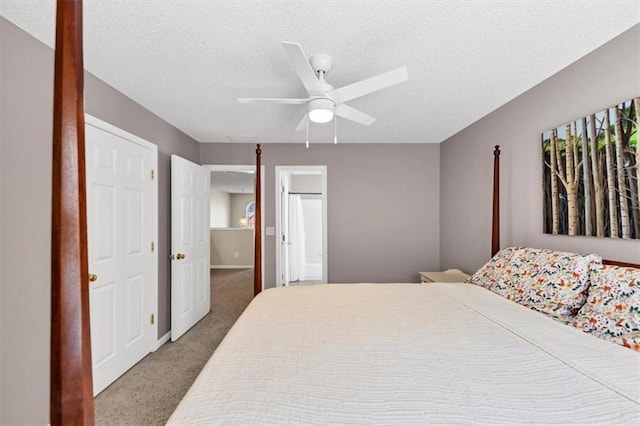 bedroom with a ceiling fan, a textured ceiling, visible vents, carpet floors, and baseboards