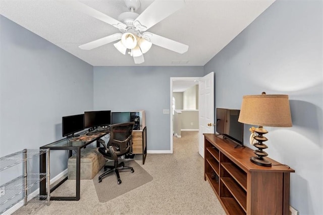office space with baseboards, carpet, and a ceiling fan