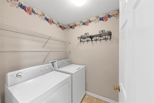 laundry area featuring laundry area, a textured ceiling, baseboards, and separate washer and dryer