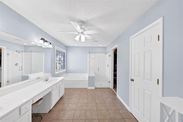 full bathroom featuring a garden tub, ceiling fan, tile patterned floors, a sink, and a stall shower
