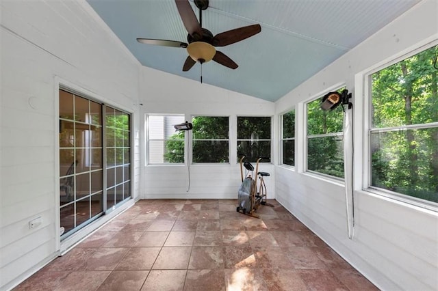 unfurnished sunroom with a ceiling fan, stone finish flooring, and lofted ceiling