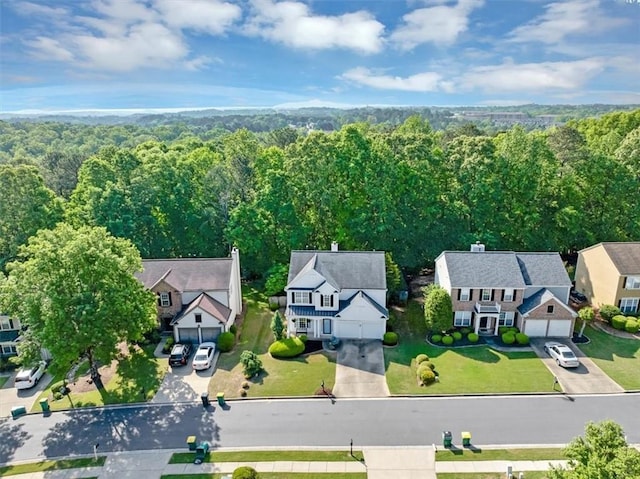 aerial view featuring a view of trees and a residential view
