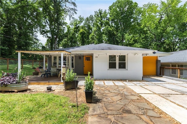 view of front of property featuring fence and a wooden deck