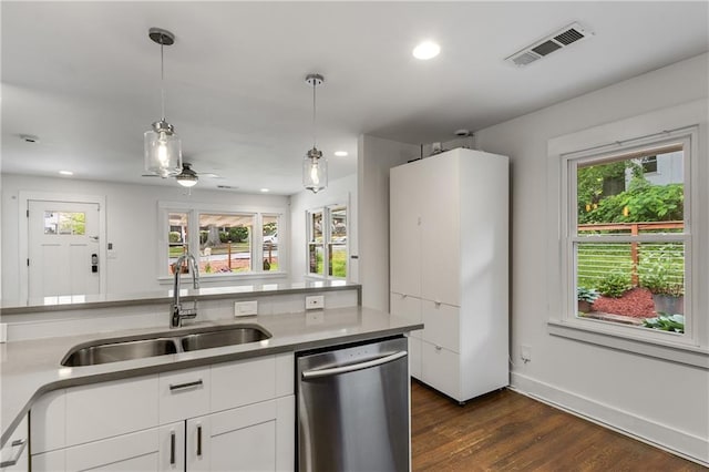 kitchen with dishwasher, a sink, white cabinetry, dark wood-style flooring, and decorative light fixtures