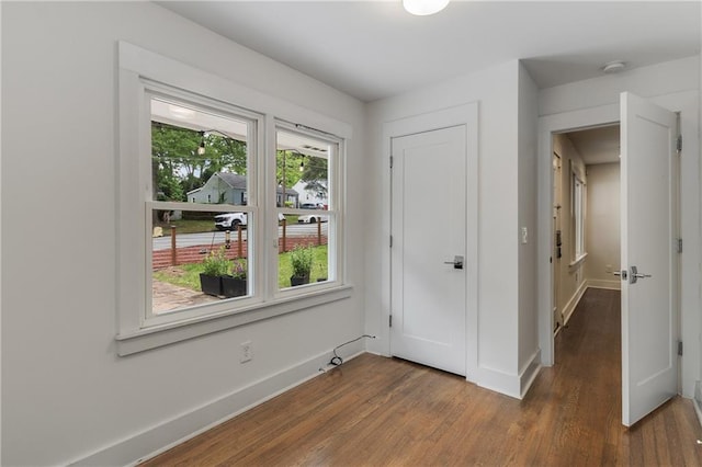 unfurnished bedroom featuring wood finished floors and baseboards