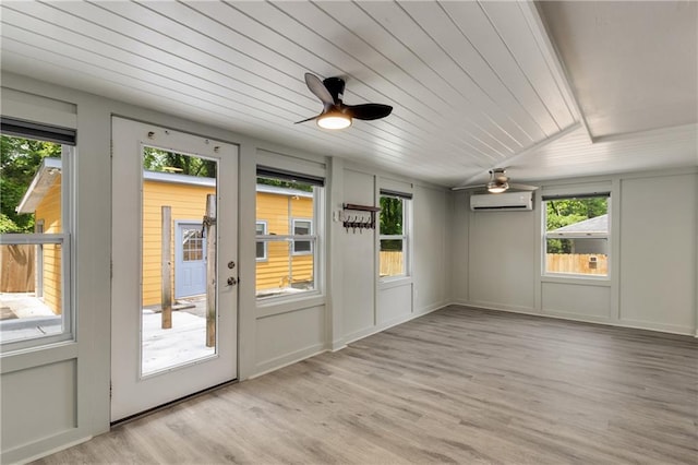 doorway to outside featuring a wall mounted AC, plenty of natural light, a ceiling fan, light wood-style floors, and wood ceiling