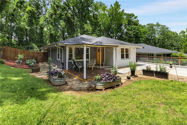 back of property featuring a garden, a patio, and concrete driveway