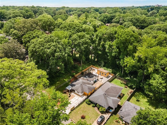 aerial view of property and surrounding area featuring a forest