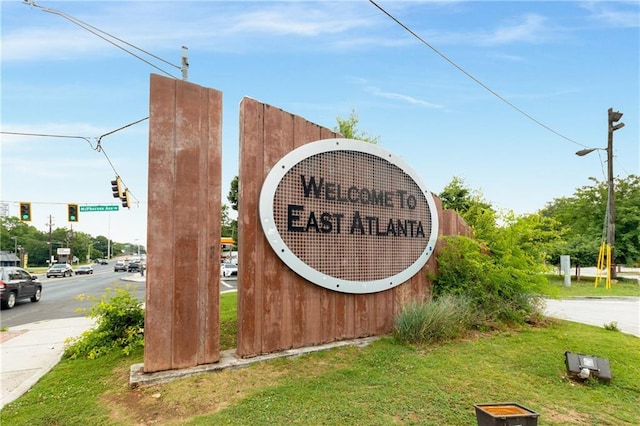 community / neighborhood sign with a lawn