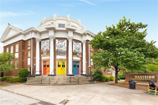 view of exterior entry featuring brick siding