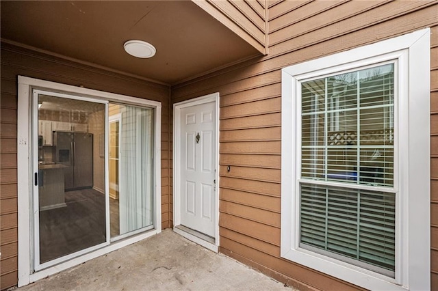 property entrance with a patio area