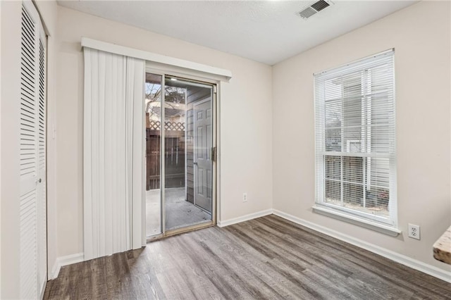 unfurnished dining area with a wealth of natural light and hardwood / wood-style floors