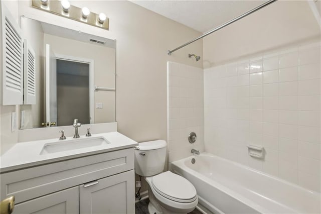 full bathroom with vanity, toilet, and tiled shower / bath