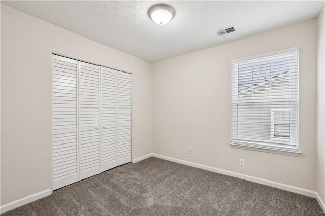 unfurnished bedroom featuring a closet and carpet flooring