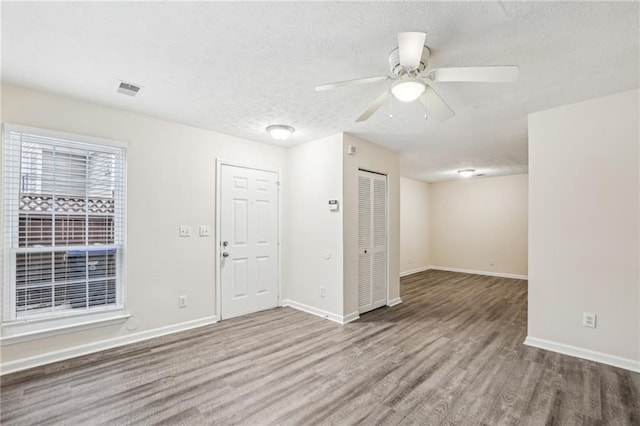 spare room with ceiling fan and wood-type flooring