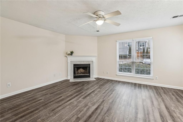 unfurnished living room featuring ceiling fan, a textured ceiling, and wood-type flooring