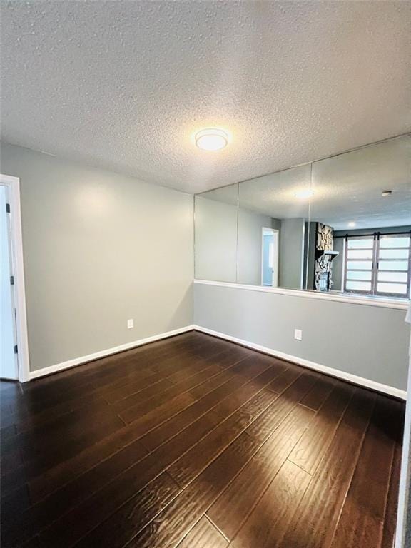 3432 Ivys Walk, Atlanta, GA 30340 - unfurnished room featuring baseboards, dark wood-style flooring, and a textured ceiling