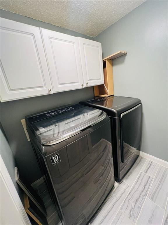 3432 Ivys Walk, Atlanta, GA 30340 - laundry room with cabinet space, washing machine and dryer, a textured ceiling, and baseboards