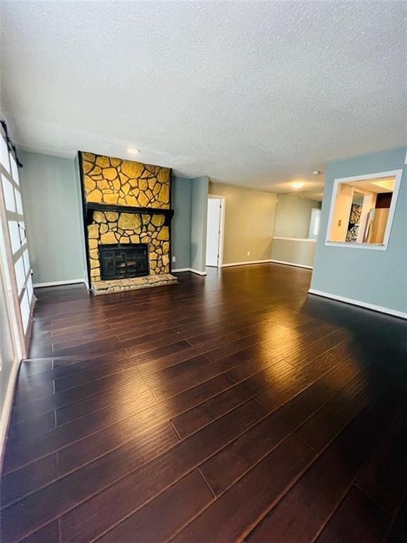 3432 Ivys Walk, Atlanta, GA 30340 - unfurnished living room with a textured ceiling, baseboards, wood-type flooring, and a fireplace