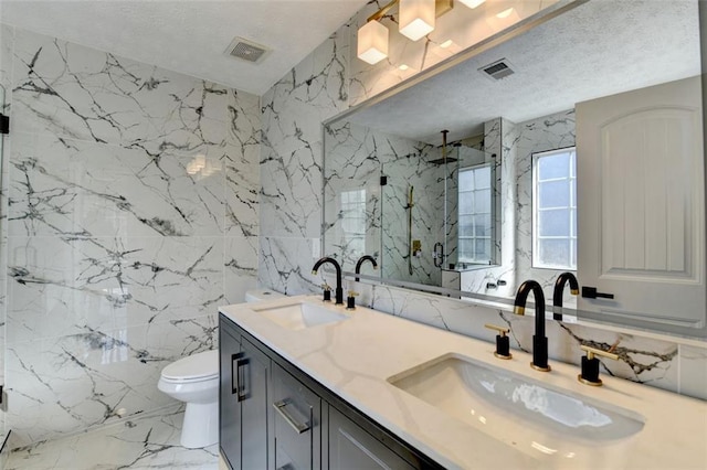 bathroom with toilet, a textured ceiling, tile walls, vanity, and a shower with door