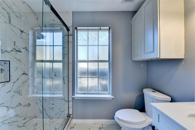 bathroom with vanity, toilet, and a shower with shower door