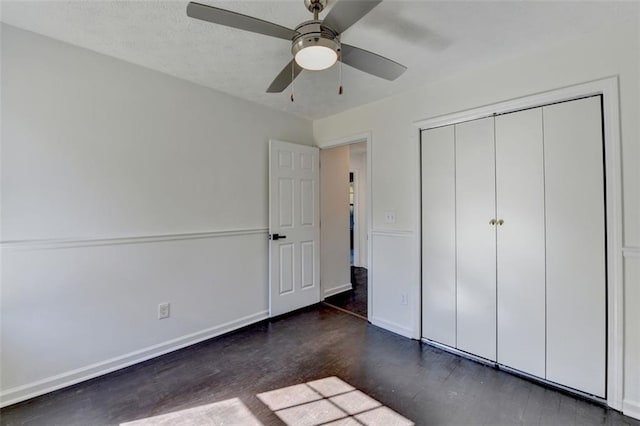 unfurnished bedroom featuring a textured ceiling, ceiling fan, and a closet