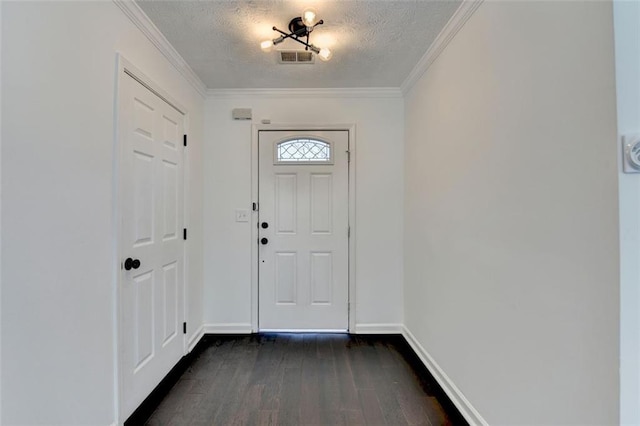 entrance foyer featuring ornamental molding, dark hardwood / wood-style floors, and a textured ceiling