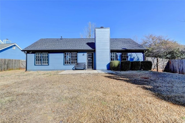 back of house with a yard and a patio area