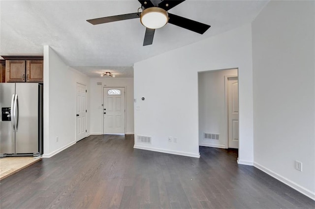 unfurnished living room featuring dark hardwood / wood-style flooring and ceiling fan