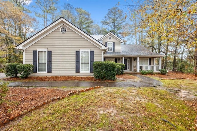 view of front of property with a porch and a front yard