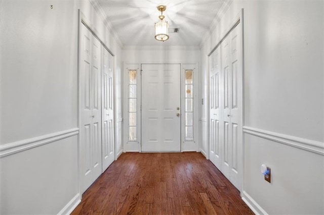 doorway to outside with crown molding and dark hardwood / wood-style flooring