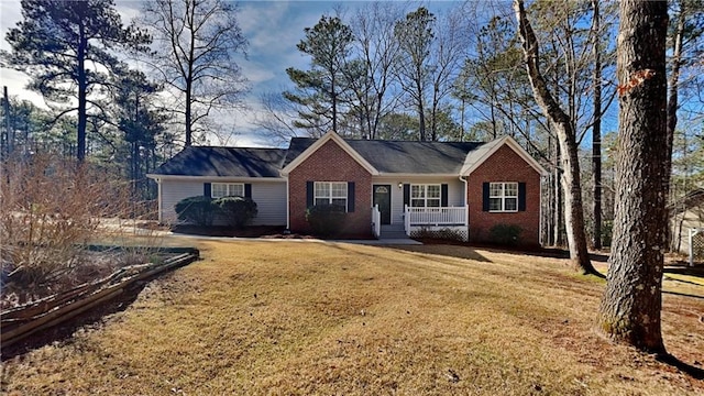 ranch-style home featuring a porch and a front lawn