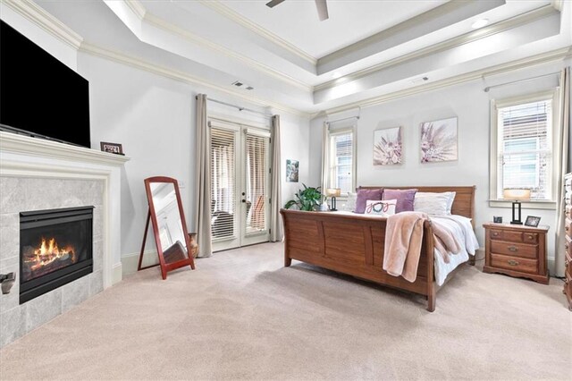 carpeted bedroom with access to outside, multiple windows, ceiling fan, and ornamental molding